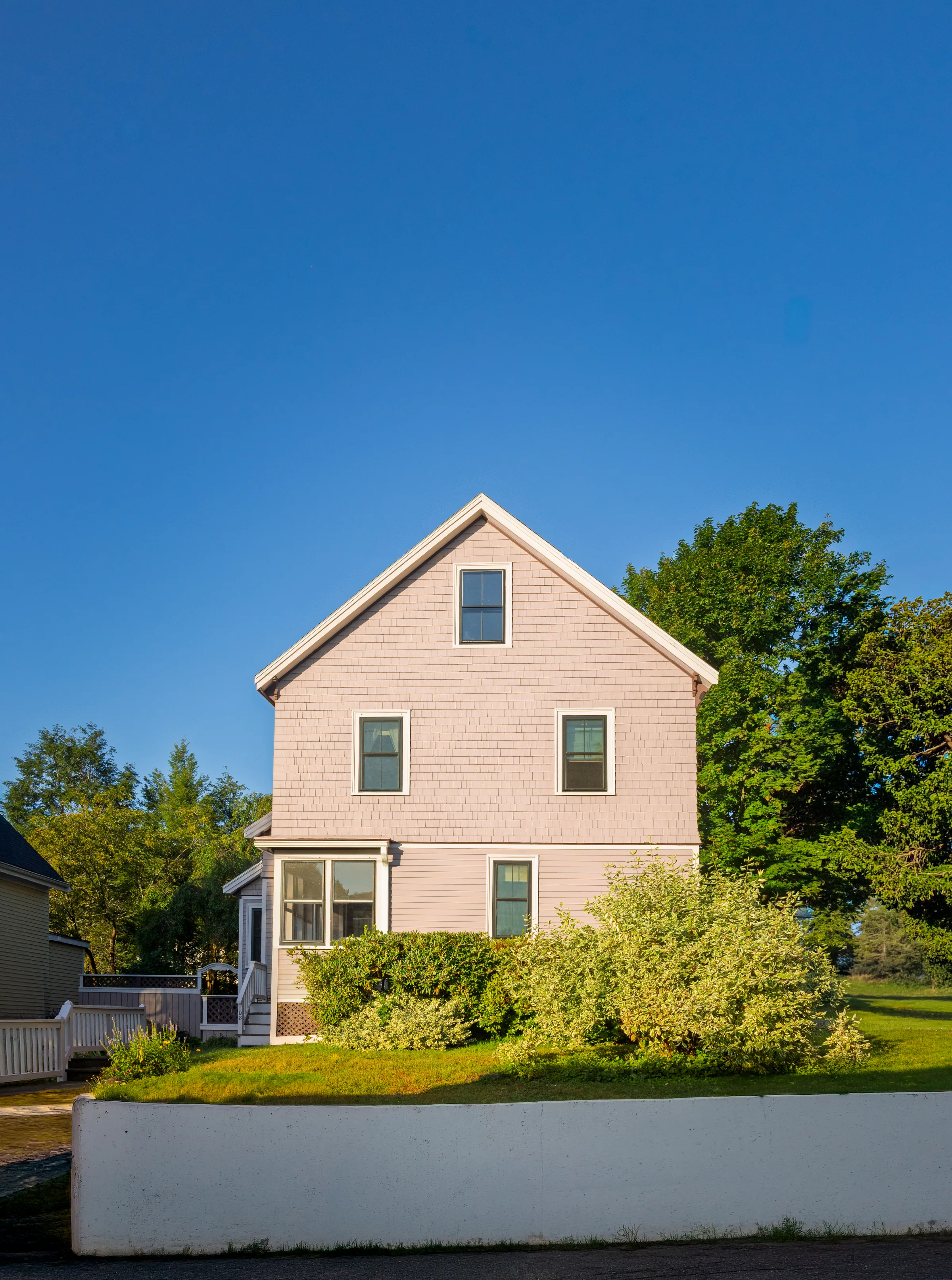 Straight-on gable elevation with mauve cedar shakes, matching siding, and light trim