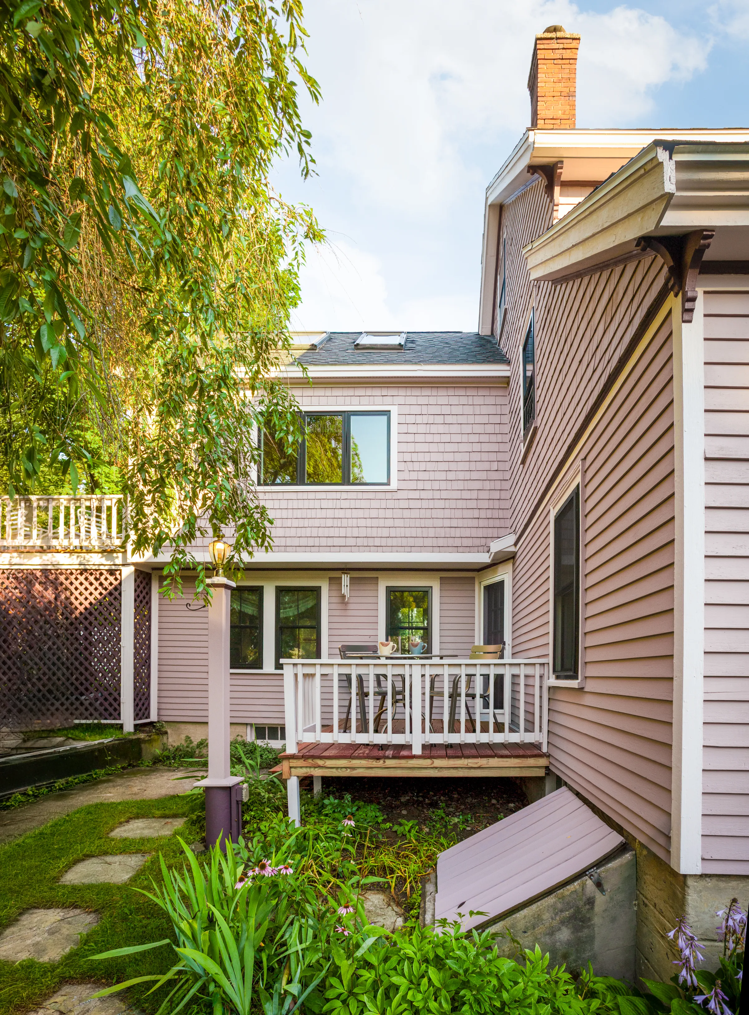 Courtyard exterior with cedar shakes, horizontal siding, light trim, and a small deck